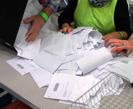 A ballot box tippling out voter slips