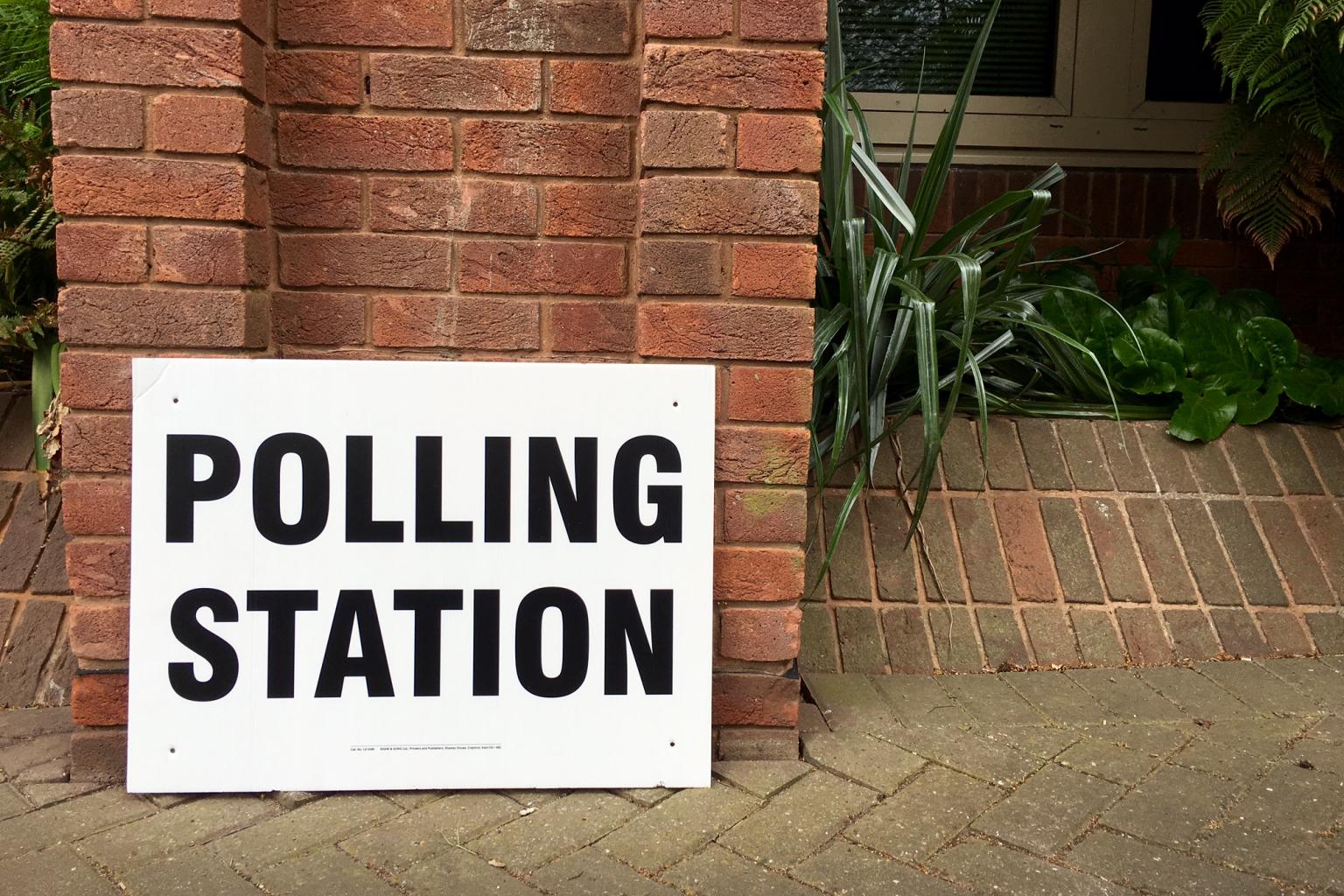 Polling station sign outside building