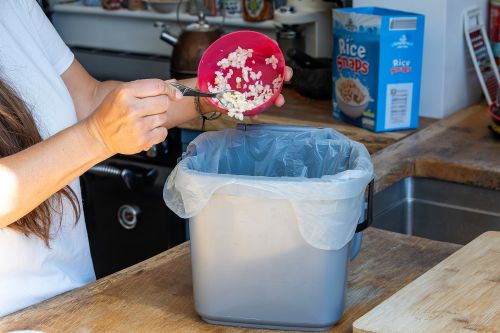 Cereal being scrapped into food waste caddy