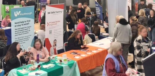 A group of people looking at stalls in a hall