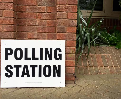 Polling station sign outside building