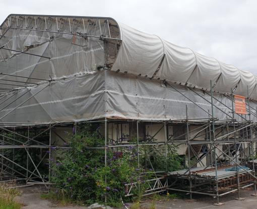 Building with roof covered in plastic