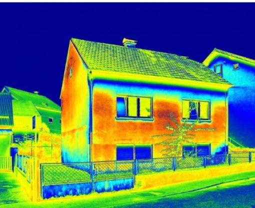 A thermal image of a detached house with green, blue and red areas showing 