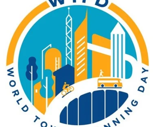 World Town Planning day logo showing cartoon buildings in orange and blue