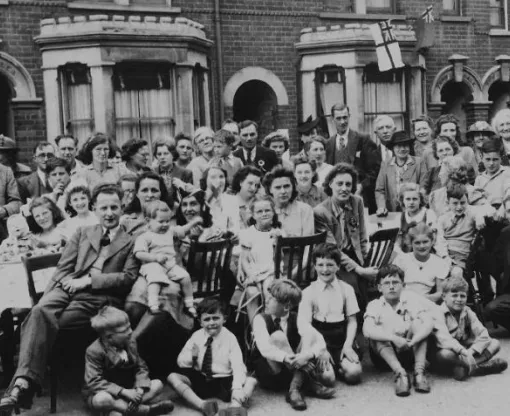 Black and white photo taken in 1945 of group of people having a street party