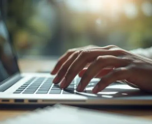 hands typing on a laptop