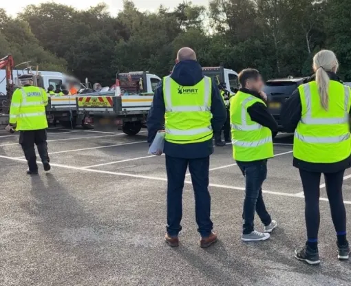 Officers in high-viz vests check vehicles
