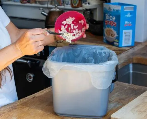Cereal being scrapped into food waste caddy