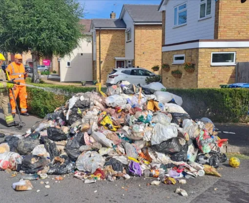 Fireman dousing a pile of rubbish 