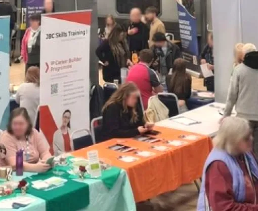 A group of people looking at stalls in a hall