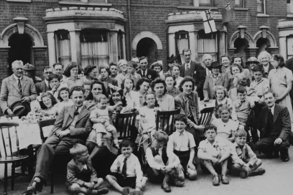 Black and white photo taken in 1945 of group of people having a street party