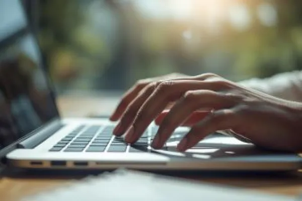 hands typing on a laptop