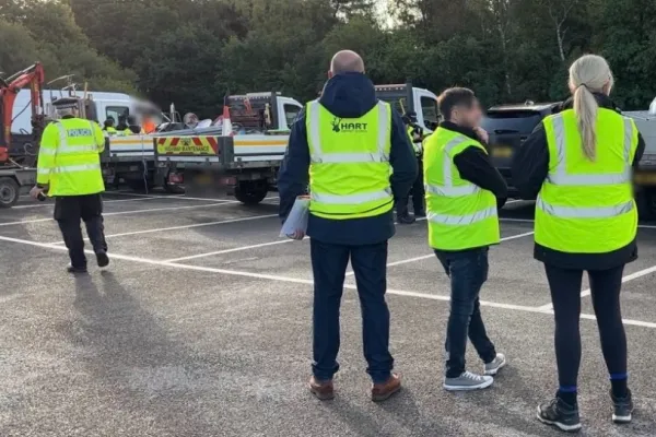 Officers in high-viz vests check vehicles