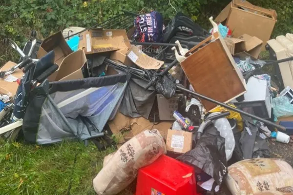 Household waste dumped in green area