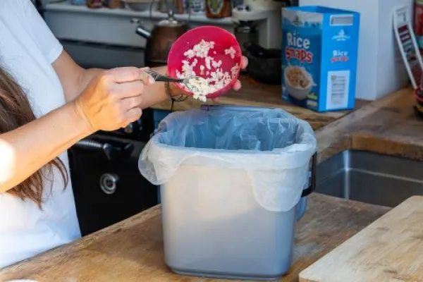 Cereal being scrapped into food waste caddy