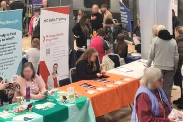 A group of people looking at stalls in a hall