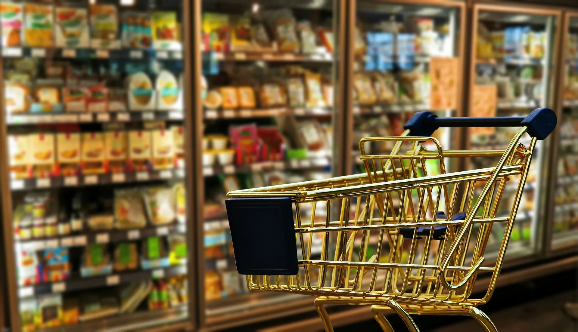 Shopping trolley in supermarket aisle