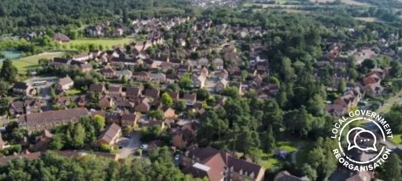 Aerial view of houses and wooded areas