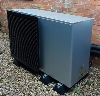 Heat pump by the wall of a house
