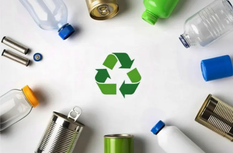 Photo of recycling symbol and lot's of plastic and tins