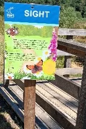 A wooden sign explaining what to do at point two. The text is mirrored on the webpage